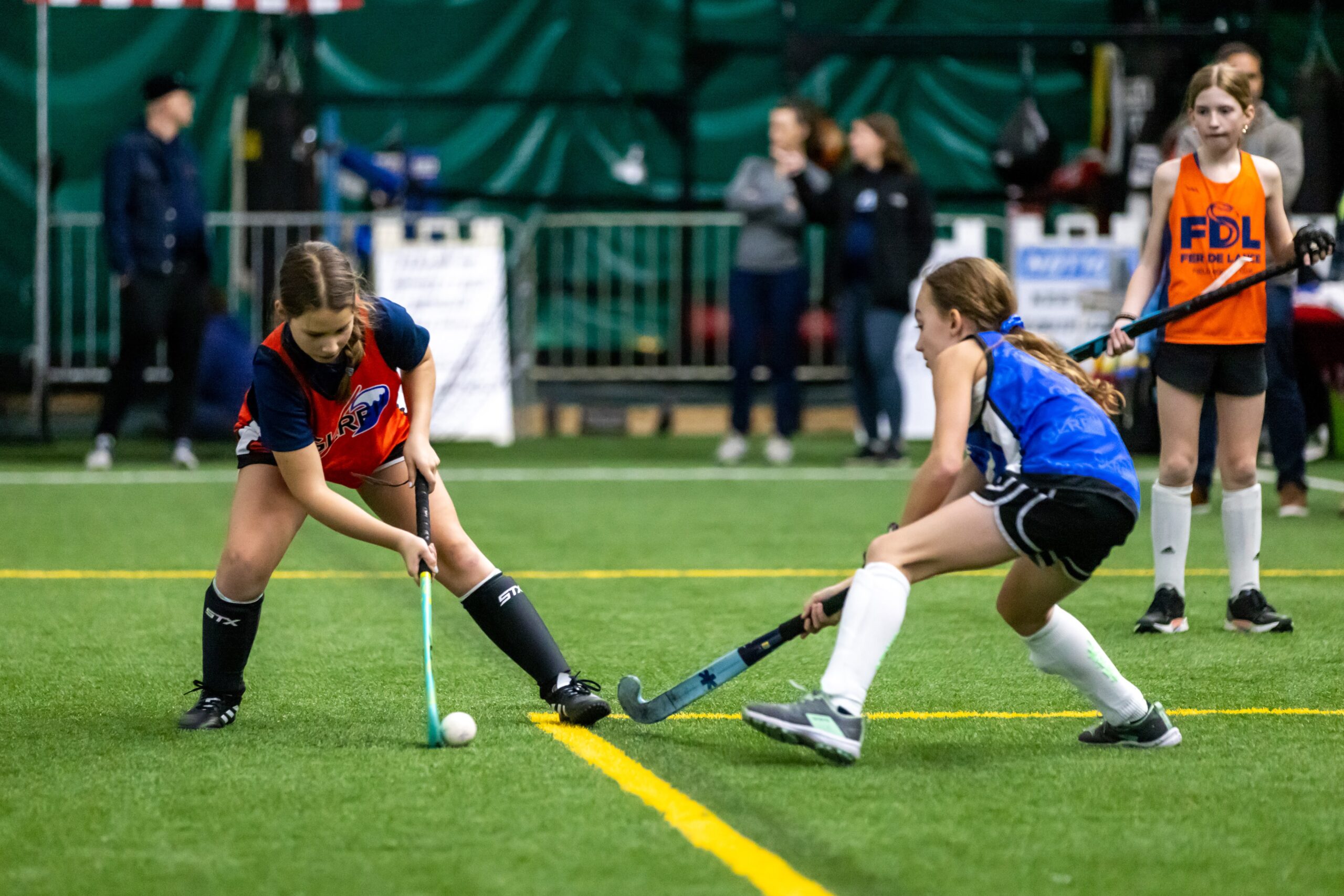 two youth field hockey players in action during a glrfh program