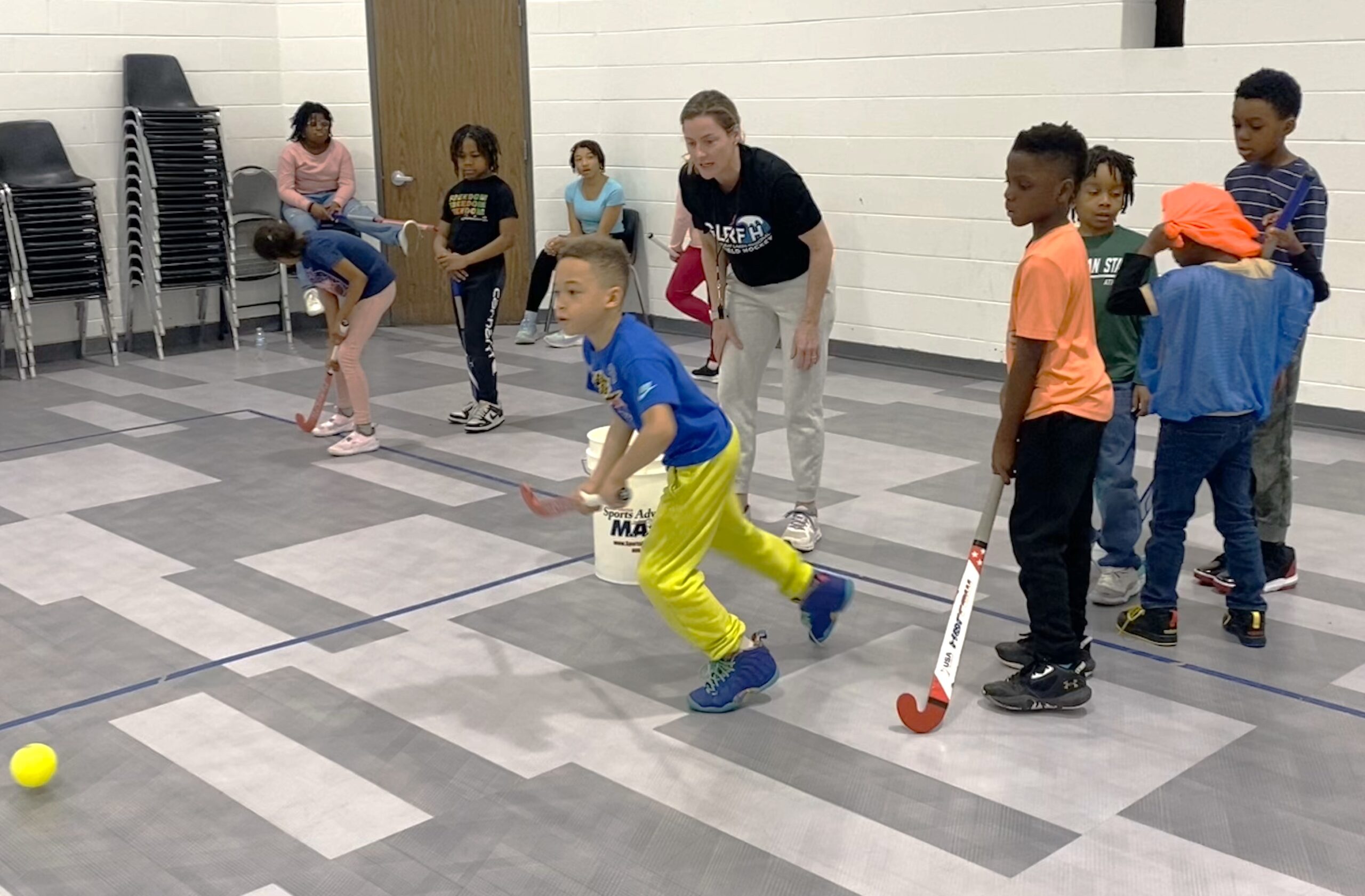 group of players participating in co-ed youth field hockey in Detroit