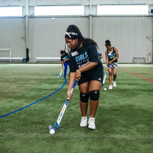 photo of an athlete learning field hockey at a girls in sports event in michigan