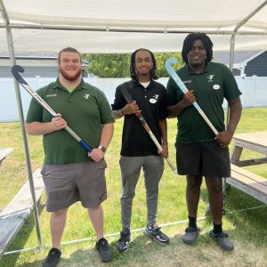 Male volunteers with great lakes regional field hockey