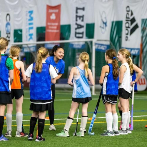 players being coached during the Hockey Untamed youth field hockey program
