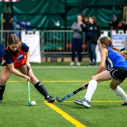two youth field hockey players in action during a glrfh program
