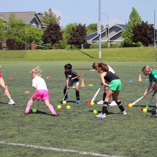 athletes participating in a summer youth field hockey clinic hosted by glrfh