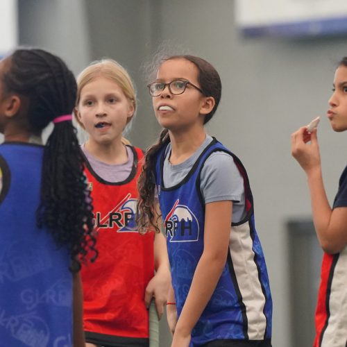 group of youth field hockey players listening during youth program