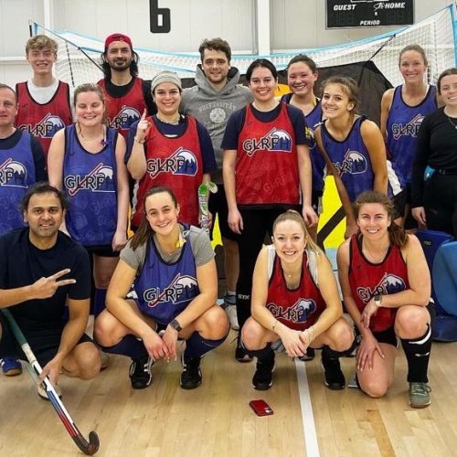 adult field hockey players from michigan playing indoor field hockey